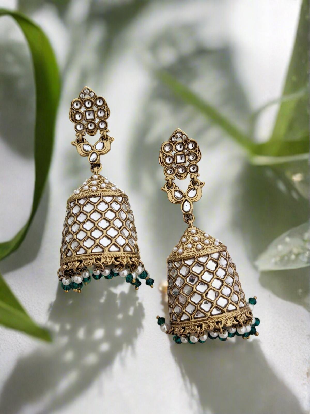 Antique gold polki stone jhumkas.